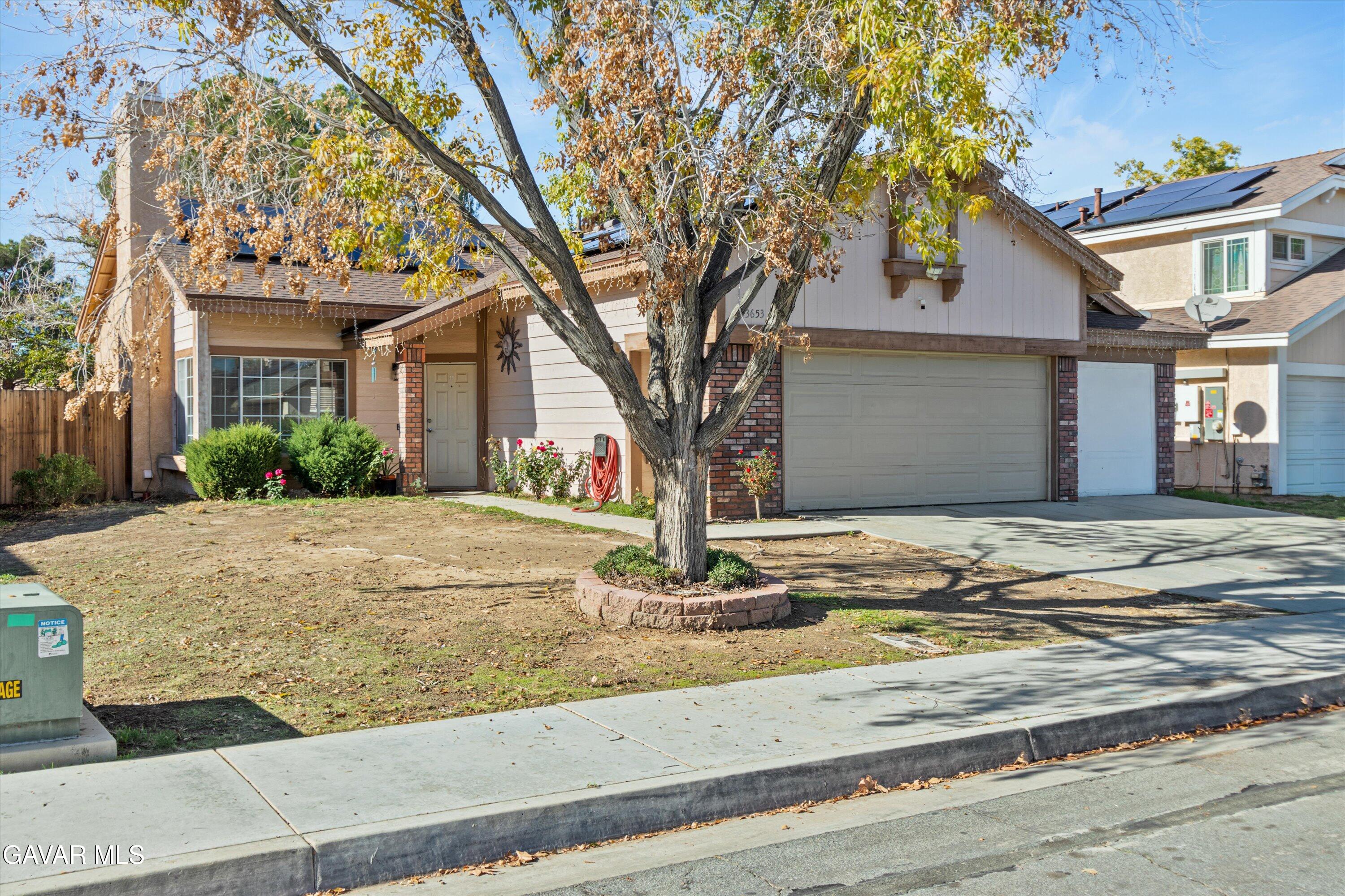 43653 Serenity Court, Unit 1 Lancaster, CA 93535 - Photo 2 of 18 a front view of a house with garden