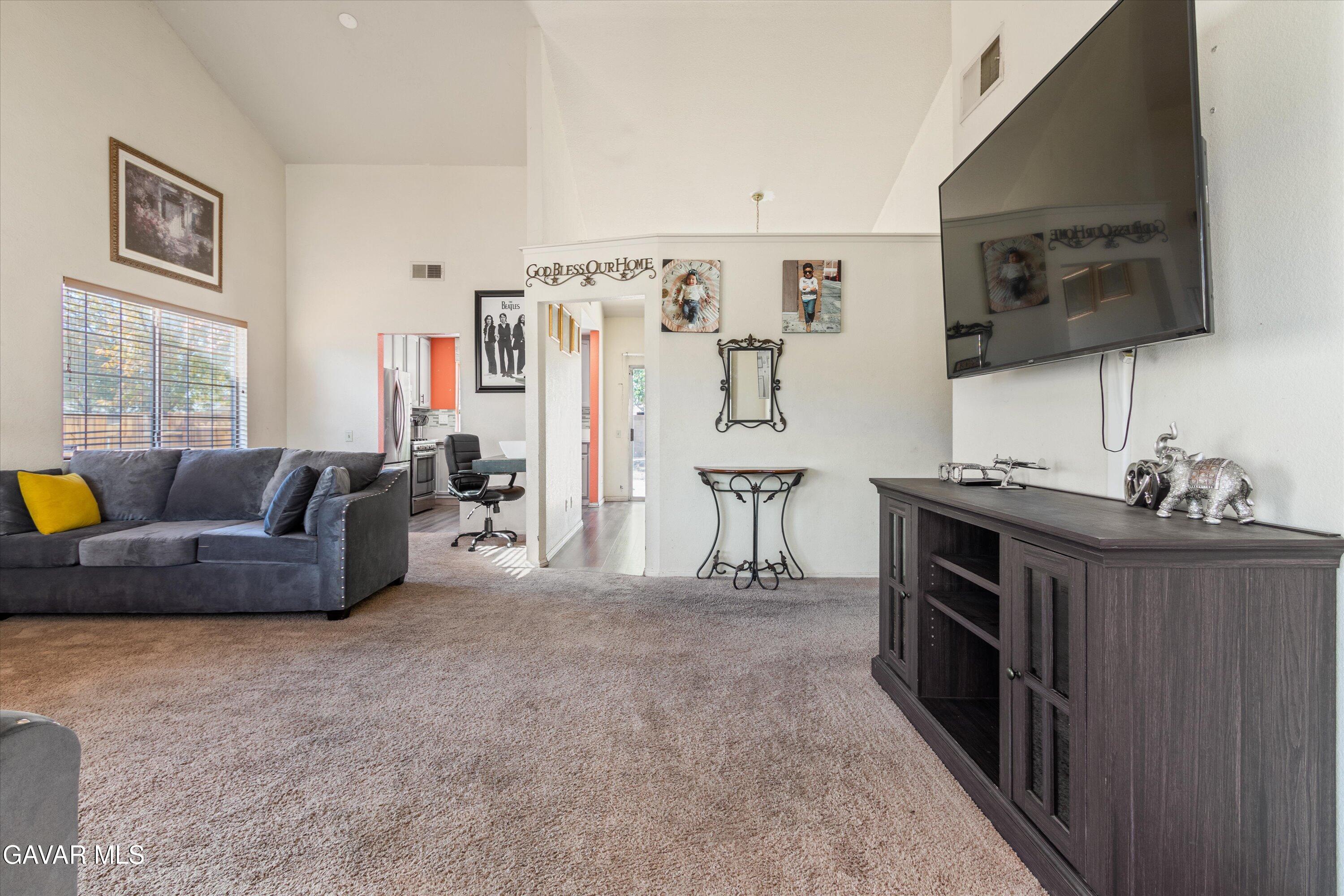 43653 Serenity Court, Unit 1 Lancaster, CA 93535 - Photo 3 of 18 a living room with furniture and a flat screen tv