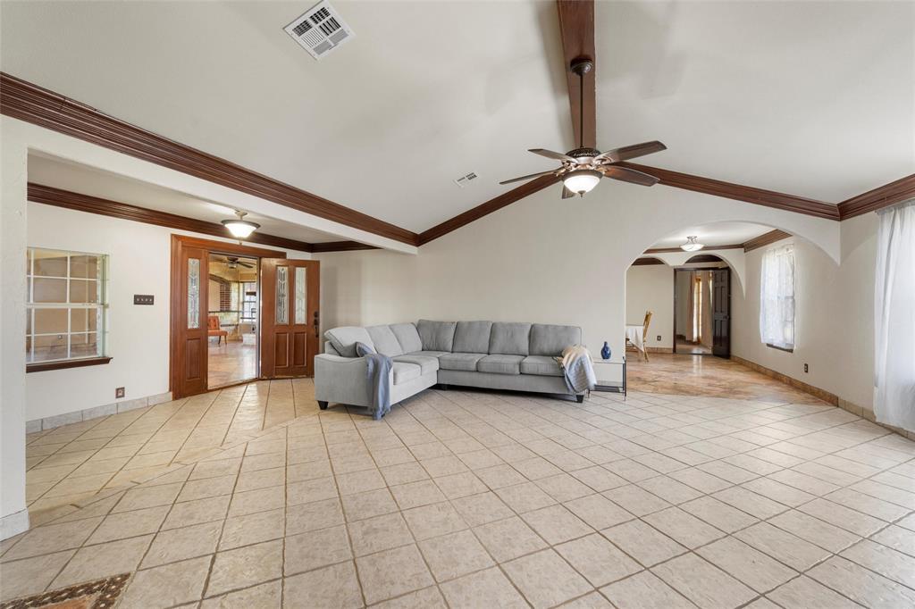 3433 West Tours Road West, TX 76691 - Photo 8 of 40 Living area featuring a ceiling fan, light tile patterned floors, and ornamental molding