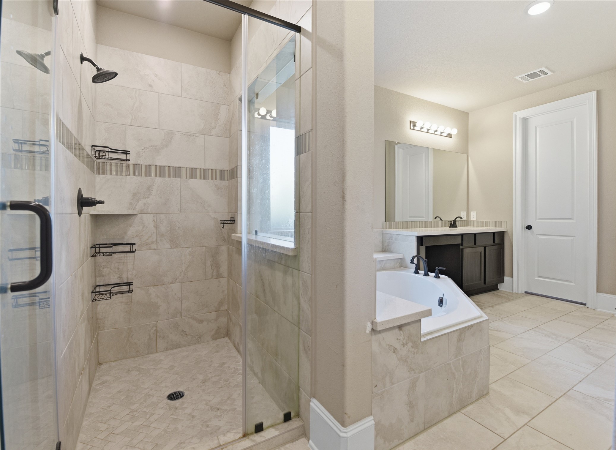 17501 Spice Merlot Lane Conroe, TX 77302 - Photo 29 of 50 a bathroom with a tub sink shower and mirror