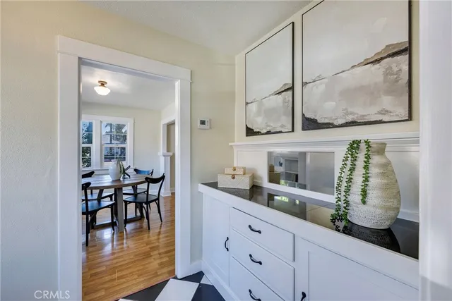 a dining hall with stainless steel appliances kitchen island granite countertop a table and chairs