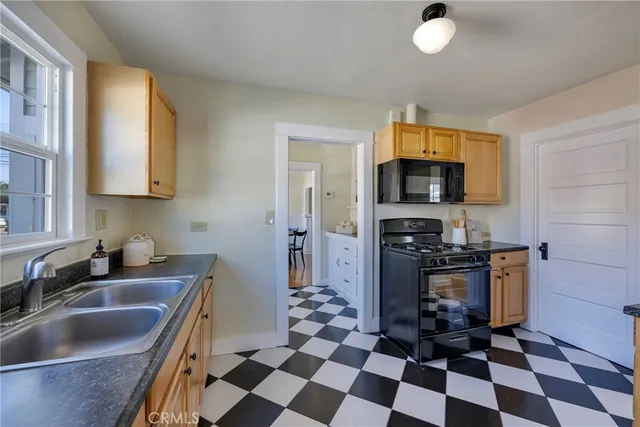 a kitchen with a stove a sink and a microwave