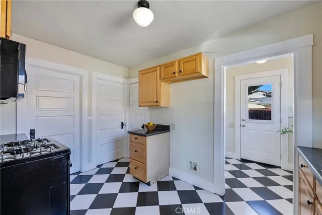 a kitchen with a checkered floor and a stove top oven