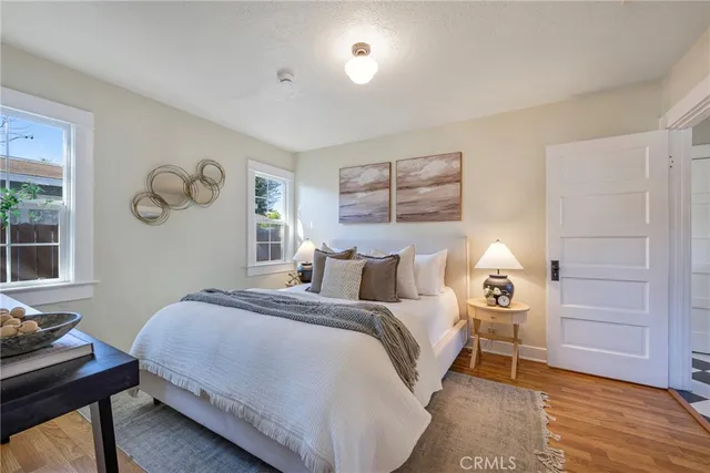 a bedroom with a bed and wooden floor