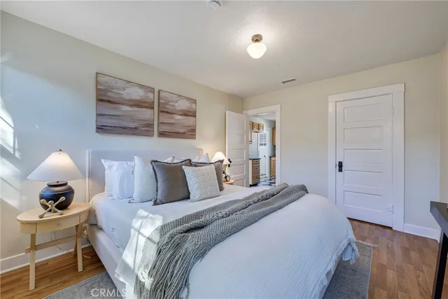 a bedroom with a bed and wooden floor