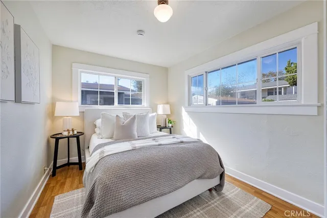 a bedroom with a bed and a painting on the wall