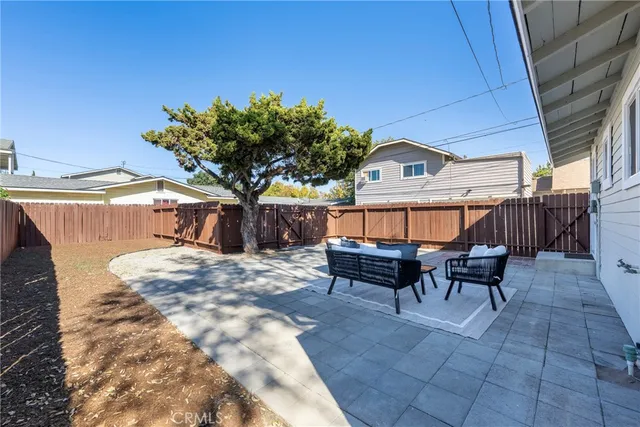 a backyard of a house with table and chairs