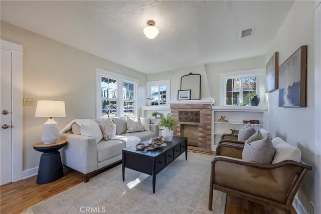 a living room with furniture a fireplace and a window