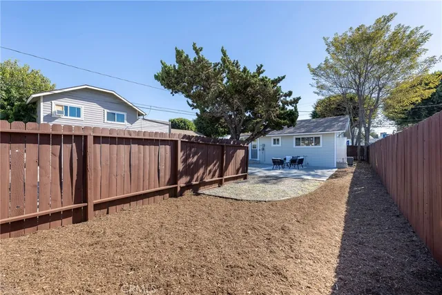 a backyard of a house with wooden fence