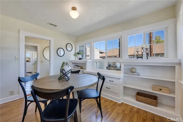 a view of a dining room with furniture and a wooden floor