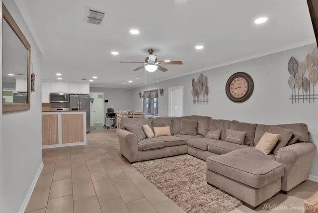 a living room with furniture kitchen view and a table