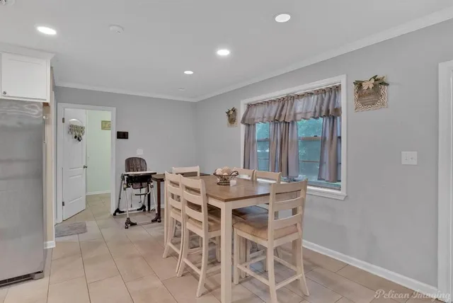 a dining room with a table and chairs