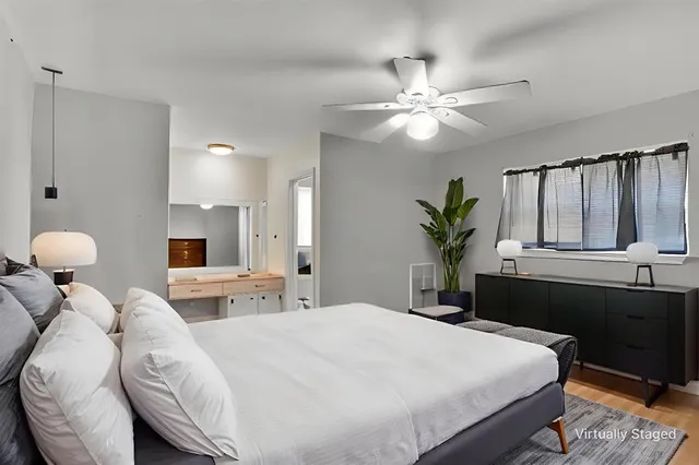 a bedroom with a large bed and a chandelier
