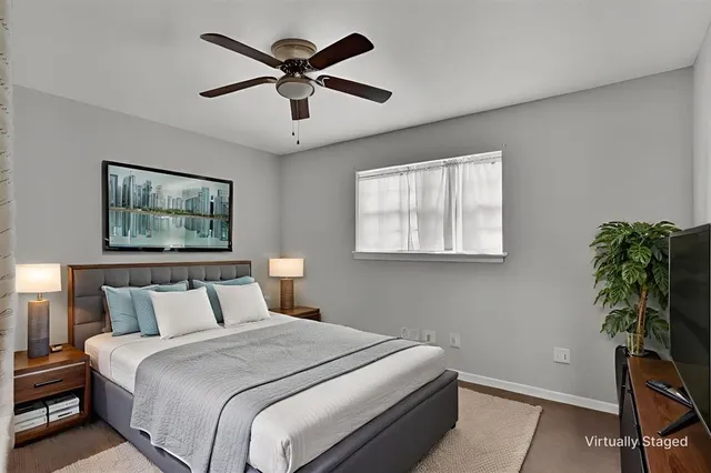 a bedroom with a bed and a painting on the wall