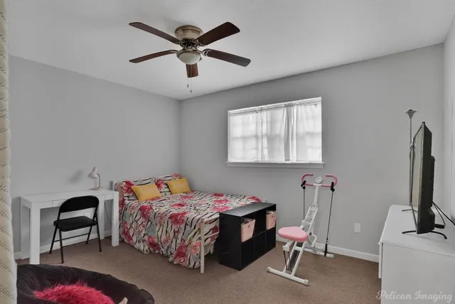 a bedroom with a bed a desk and chair