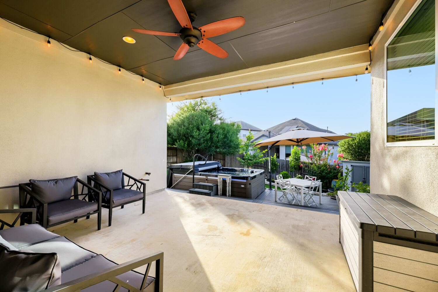 621 Rancho Sienna Loop Georgetown, TX 78628 - Photo 23 of 28 An inviting covered patio offers ample space for relaxation and entertaining, complete with a spa and verdant backyard.