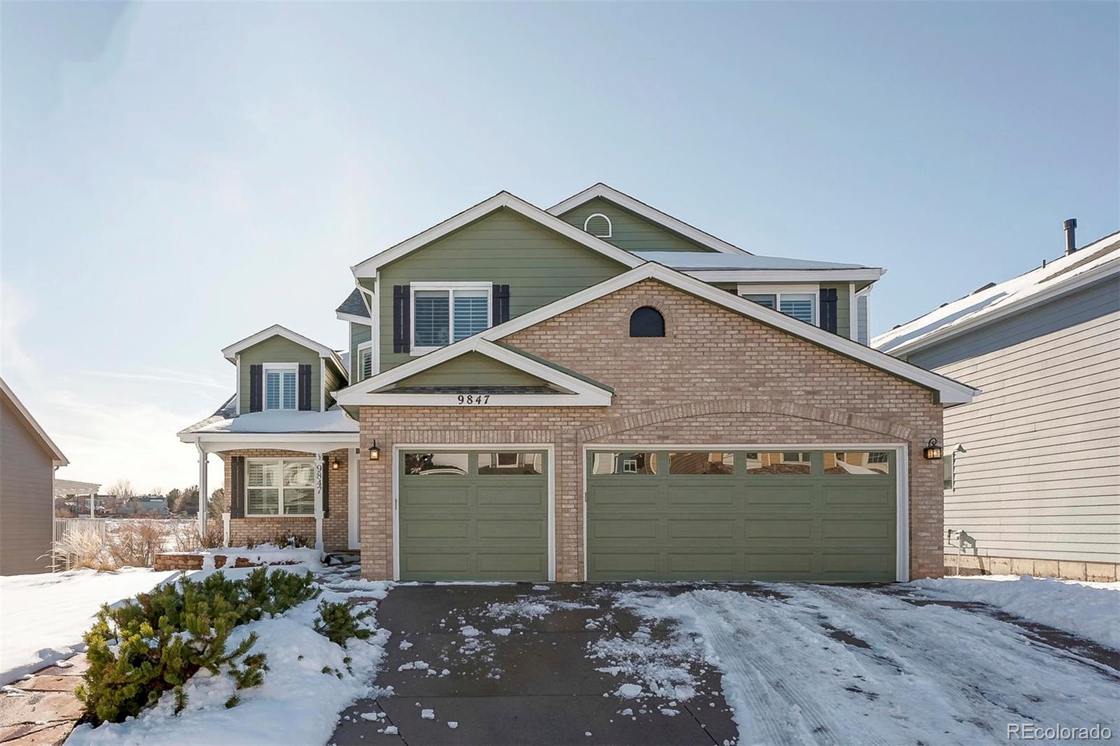 9847 Spring Hill Lane Highlands Ranch, CO 80129 - Photo 2 of 33 a front view of a house with garden