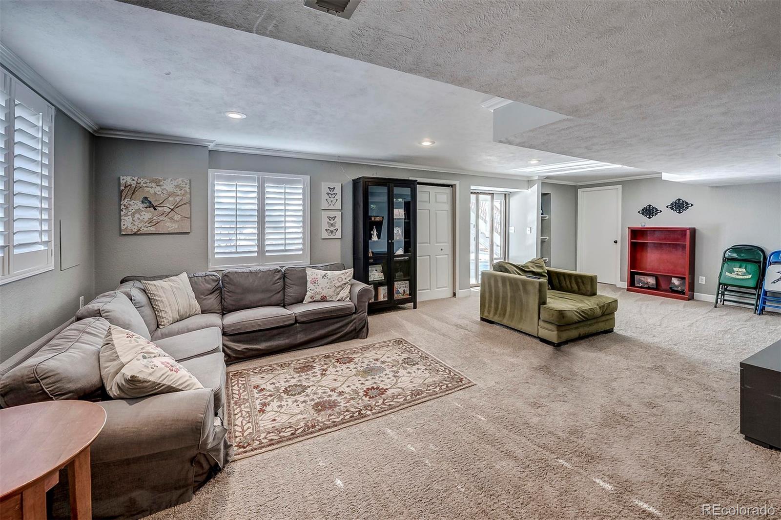 9847 Spring Hill Lane Highlands Ranch, CO 80129 - Photo 23 of 33 a living room with furniture and a flat screen tv