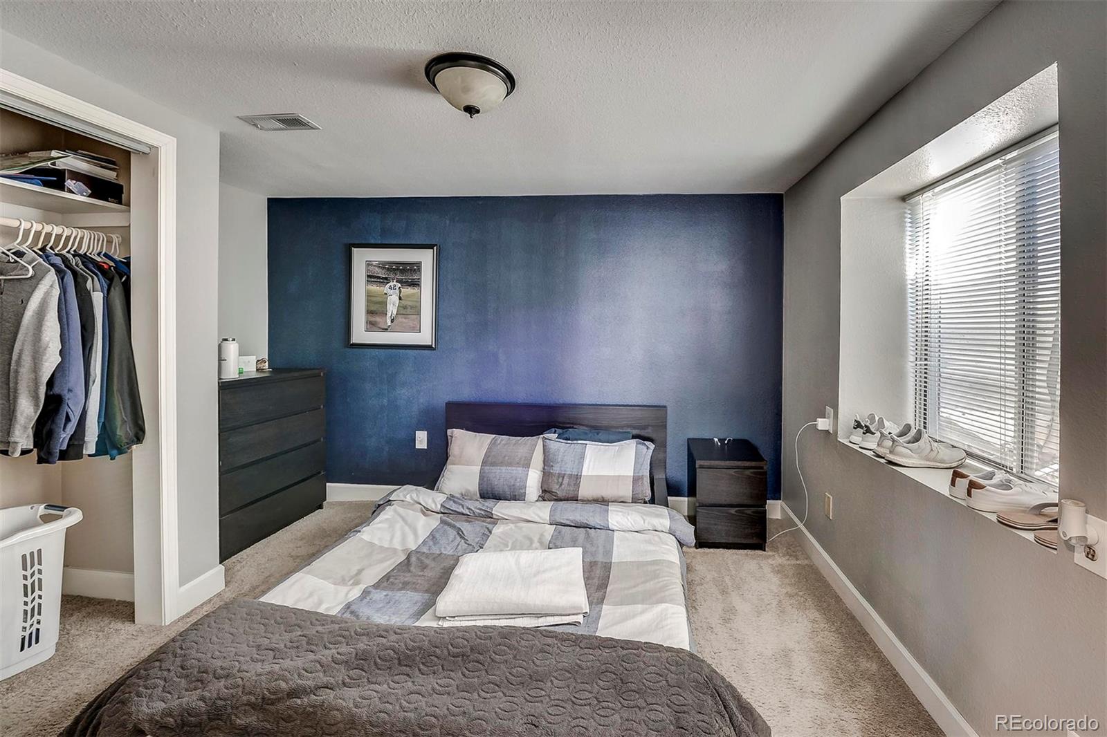 9847 Spring Hill Lane Highlands Ranch, CO 80129 - Photo 24 of 33 a bedroom with a bed and a large mirror