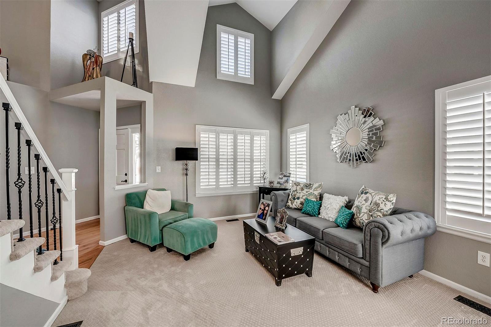 9847 Spring Hill Lane Highlands Ranch, CO 80129 - Photo 8 of 33 a living room with furniture and a large window
