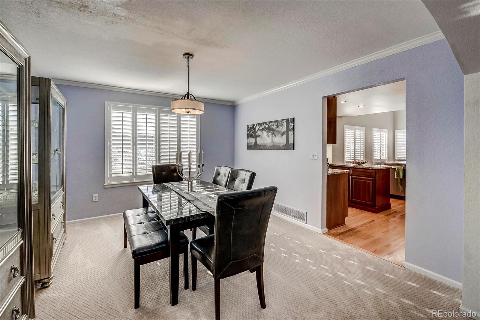 9847 Spring Hill Lane Highlands Ranch, CO 80129 - Photo 10 of 33 a view of a dining room with furniture window and wooden floor
