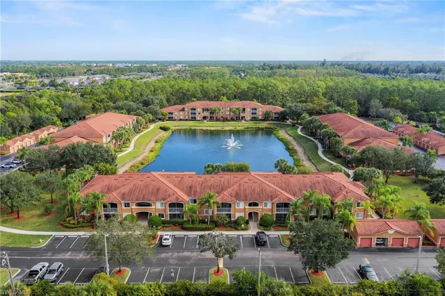 an aerial view of a house with garden space and a lake view