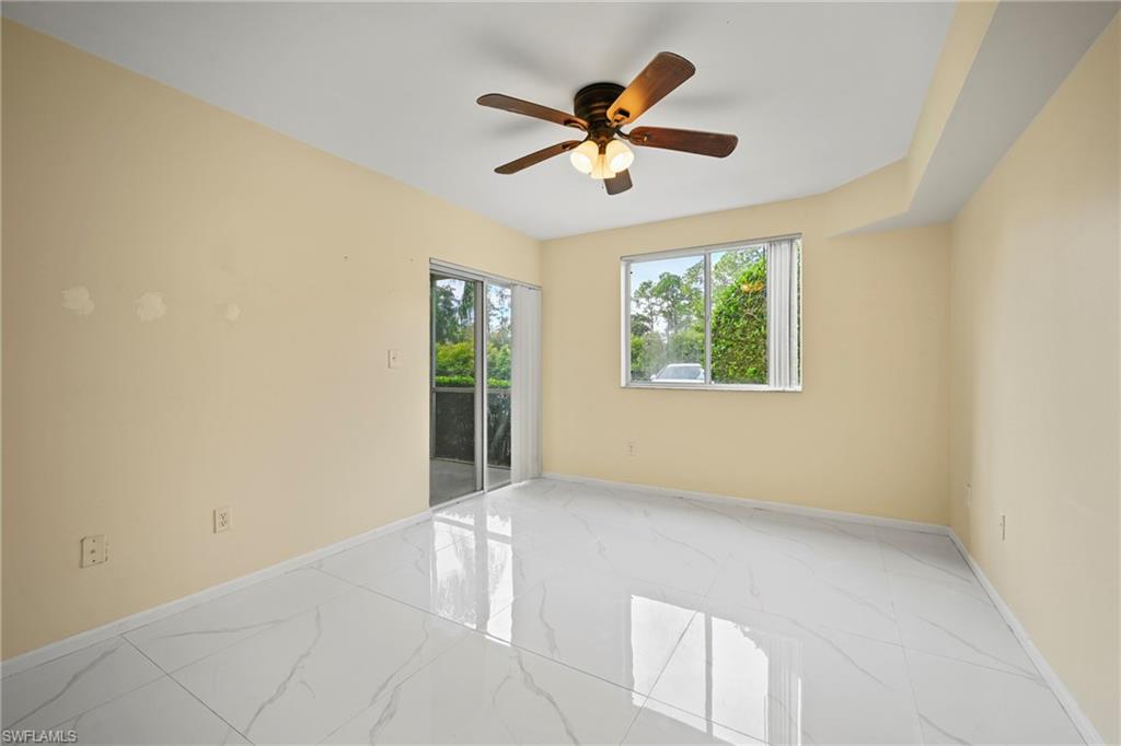 1820 Florida Club Circle, Unit 2103 Naples, FL 34112 - Photo 11 of 22 an empty room with windows and fan