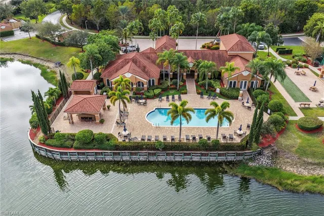 an aerial view of a house with a garden and lake view