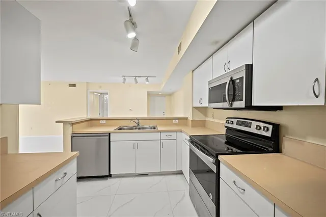 a kitchen that has a sink and a stove in it