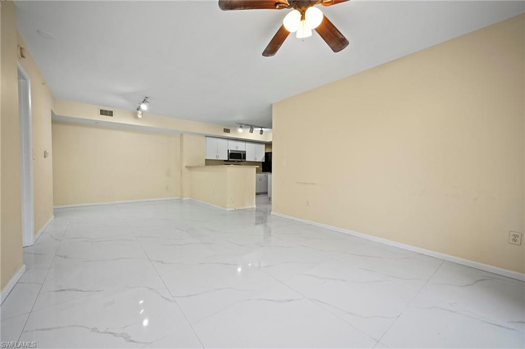 1820 Florida Club Circle, Unit 2103 Naples, FL 34112 - Photo 10 of 22 a view of a kitchen with a dishwasher and a white cabinets