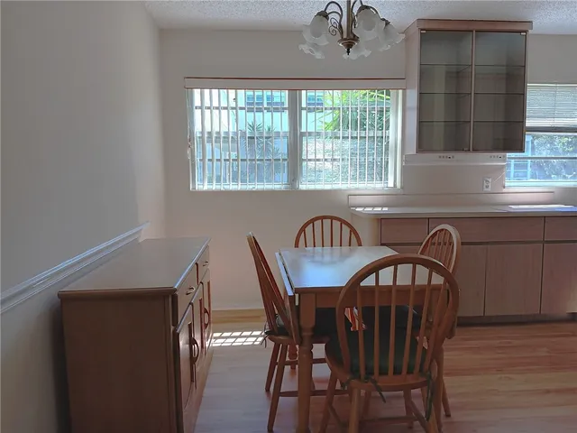 a view of a dining room with furniture and window