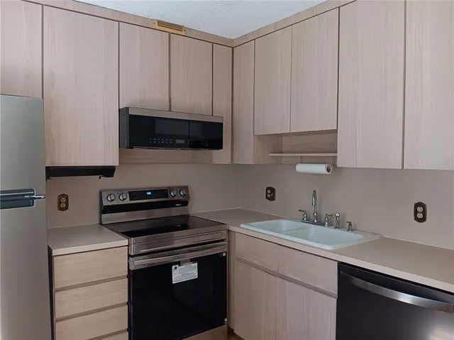 a kitchen with a sink and cabinets