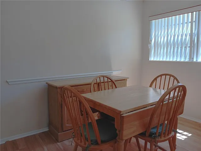 a view of a dining room that has a table and chairs