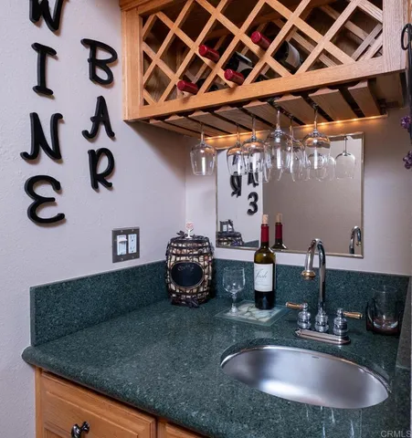 a kitchen with a sink and a mirror