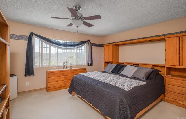 a bed room with a bed and a large window