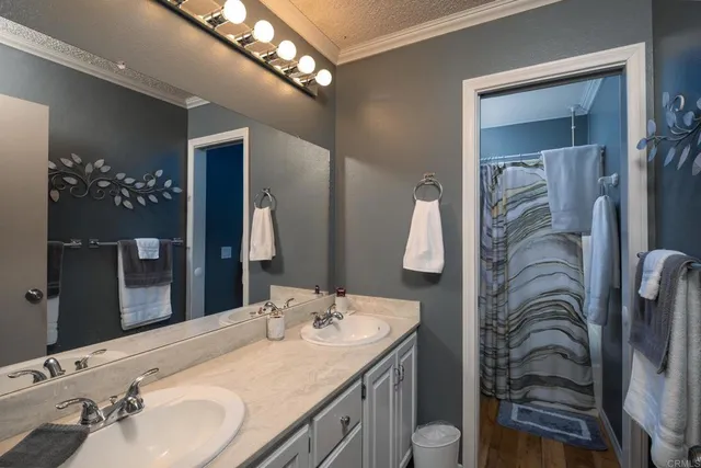 a bathroom with a double vanity sink and a mirror