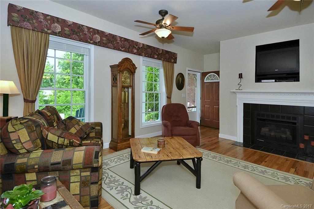 52 Rita Lane Canton, NC 28716 - Photo 4 of 19 a living room with furniture a flat screen tv and a fireplace