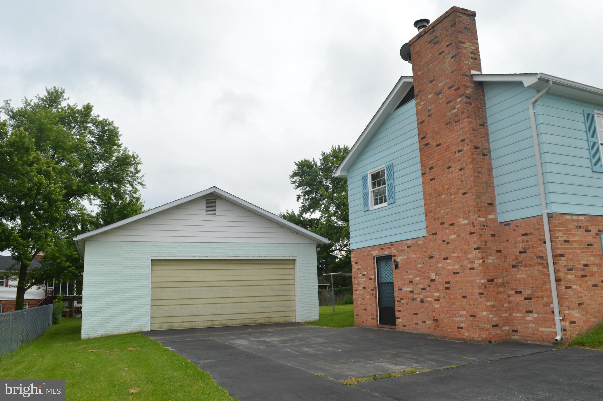 218 Ridge Road Winchester, VA 22602 - Photo 2 of 27 Garage has elec, storage, work bench, a wood stove