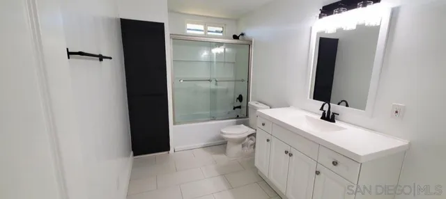 a bathroom with a toilet sink and shower