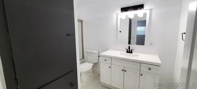 a bathroom with a sink toilet and mirror