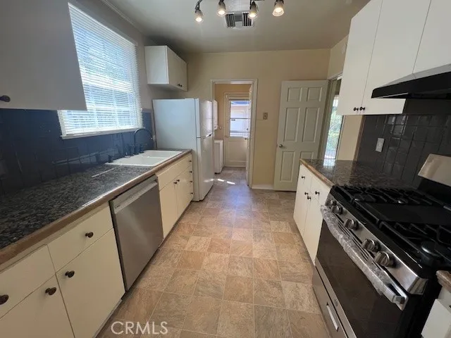 a view of a room with wooden floor and window