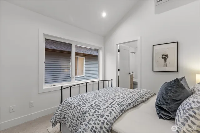 a bedroom with a bed and window