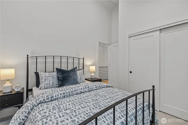 a bedroom with a bed and a lamp on table