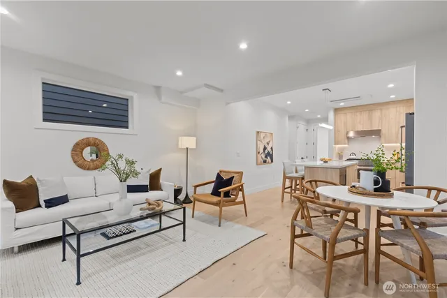 a living room with furniture a rug and white wall