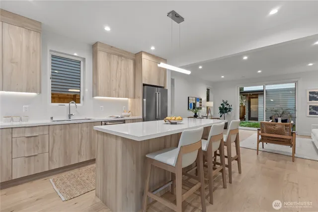 a kitchen with counter space dining table and chairs