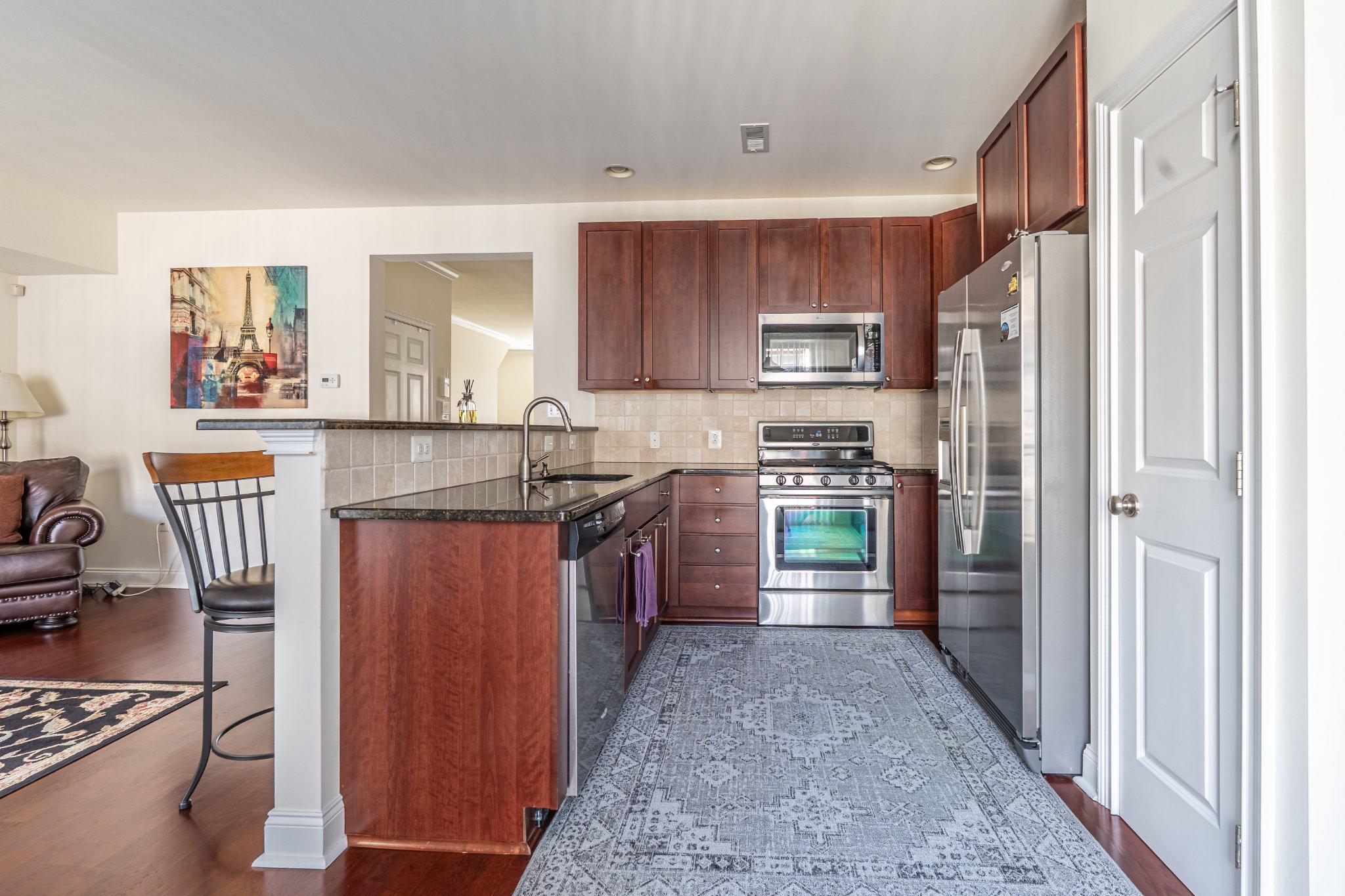 608 Captains Way Philadelphia, PA 19146 - Photo 15 of 36 a kitchen with stainless steel appliances granite countertop a refrigerator and a stove top oven