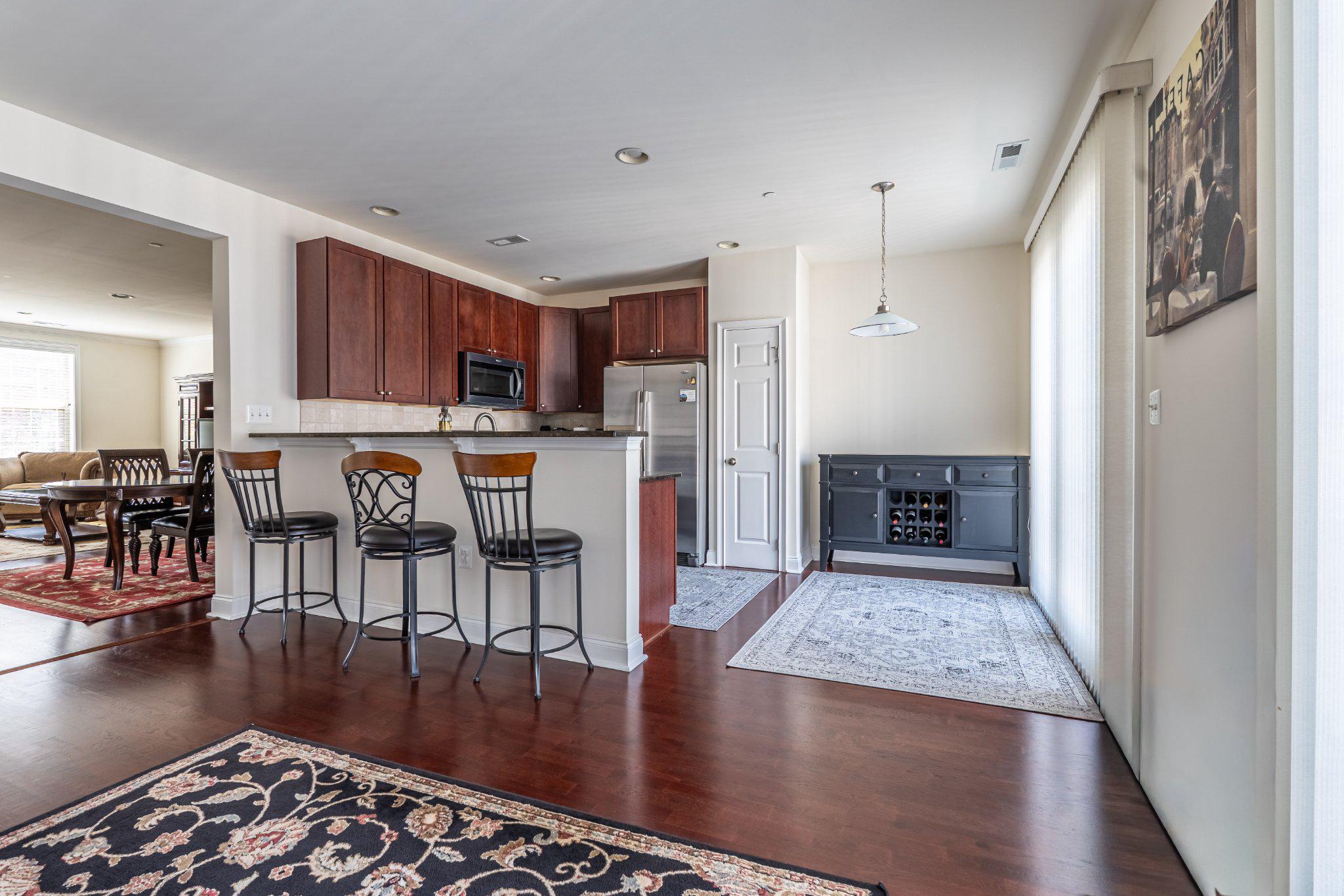 608 Captains Way Philadelphia, PA 19146 - Photo 18 of 36 a open kitchen with stainless steel appliances granite countertop a refrigerator stove top oven and a dining table with wooden floor