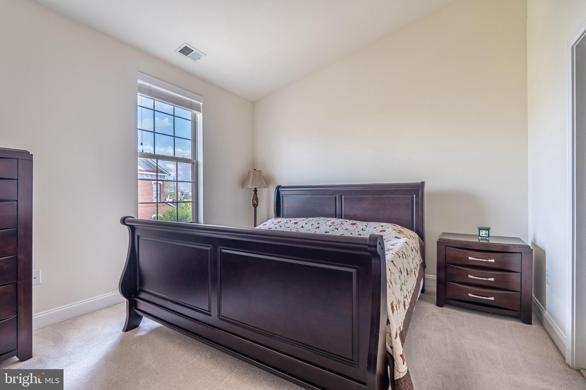 608 Captains Way Philadelphia, PA 19146 - Photo 22 of 36 a bed sitting in a bedroom next to a window with dresser