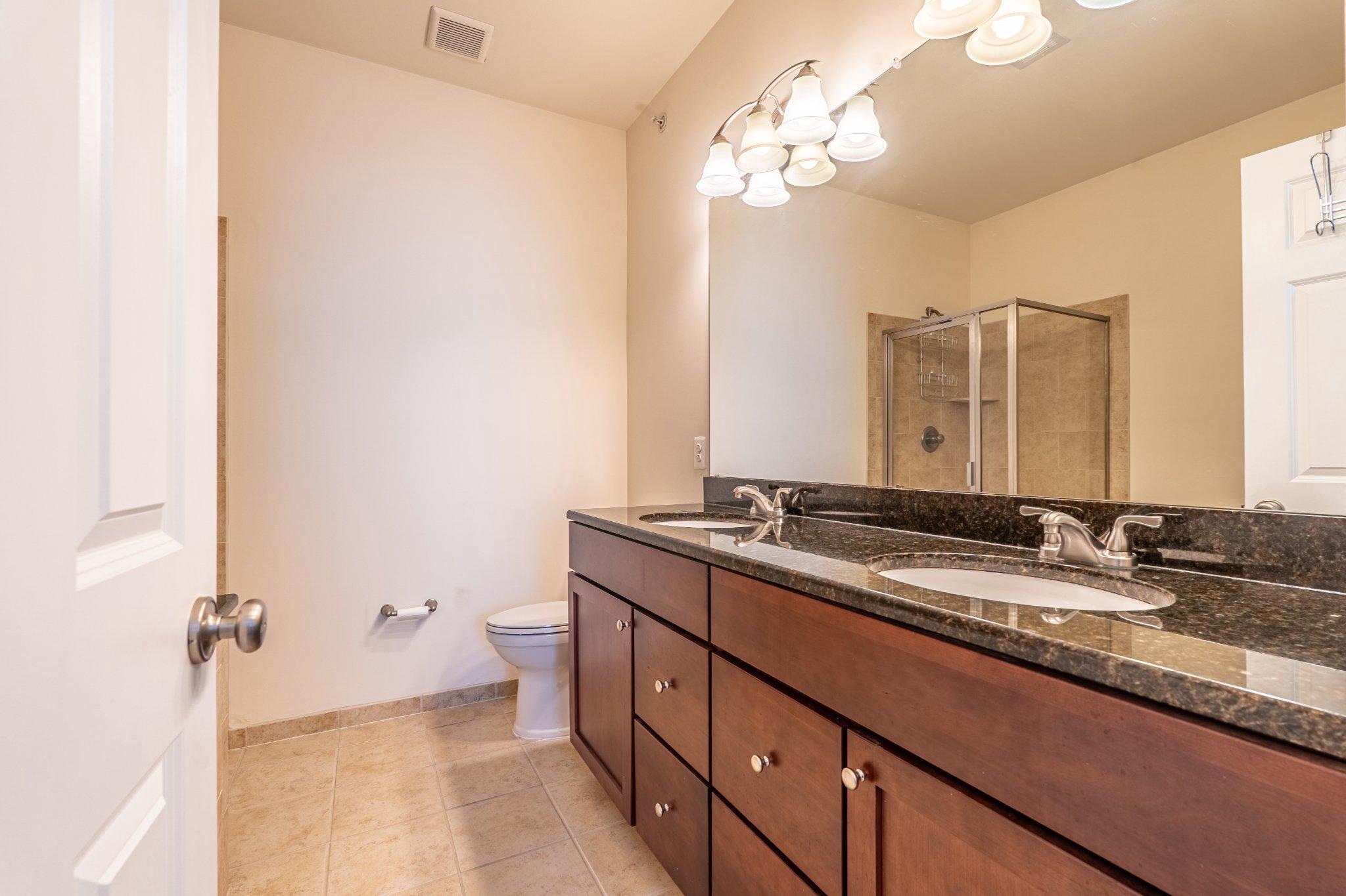 608 Captains Way Philadelphia, PA 19146 - Photo 23 of 36 a bathroom with a granite countertop double vanity sink and mirror