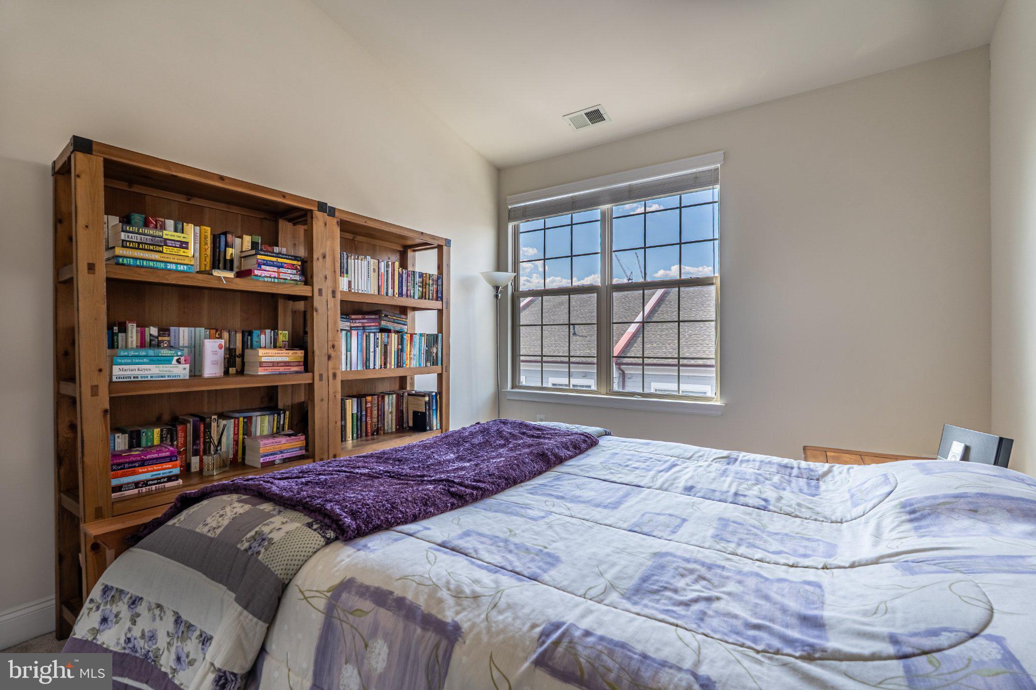608 Captains Way Philadelphia, PA 19146 - Photo 32 of 36 a bedroom with a bed cabinets and a book shelf